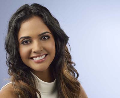 Head-and-shoulders photo of young woman with long dark hair wearing a sleeveless white mock-neck shirt, for information on emax from Hoffman Estates dentist Dr. Becker.