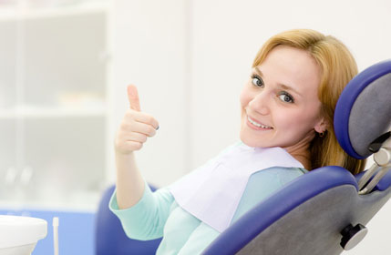 woman giving a thumbs up in the dental chair