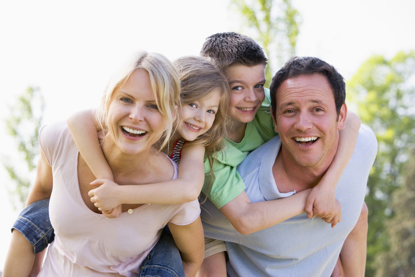 Mother, father, son, and daughter with the children on their parent's backs.