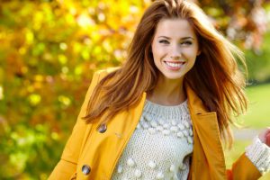 Woman in autumn colors with a beautiful smile